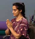 sitting woman holding hands in namaste position